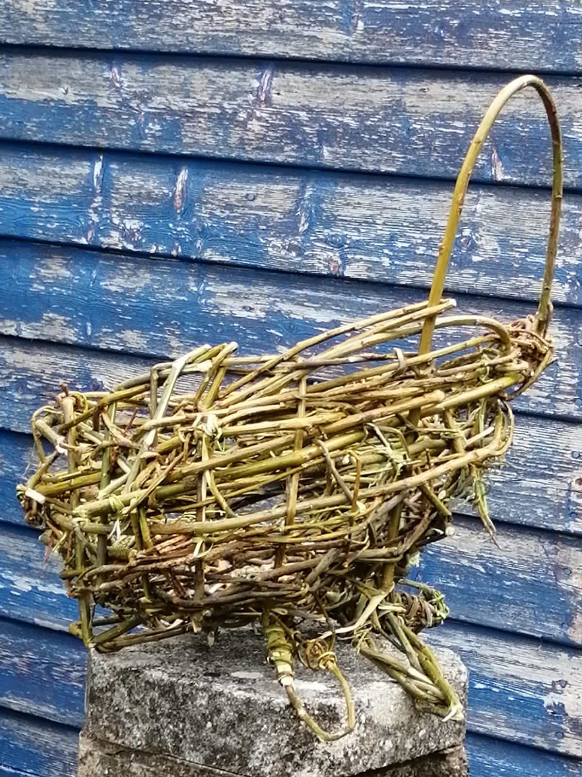 Photo of the willow basket looking a bit like a toy pushchair